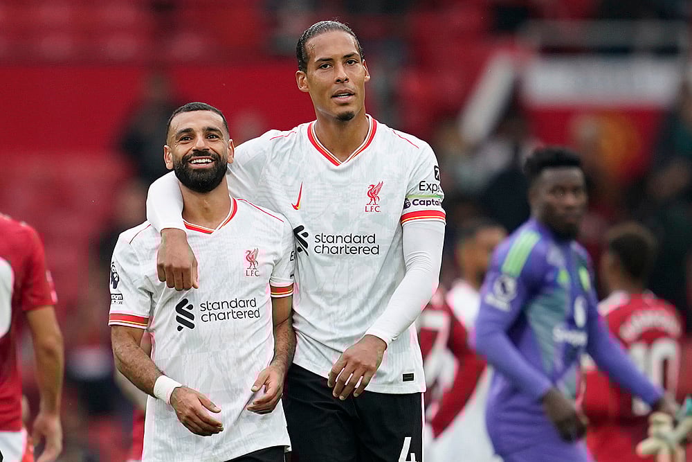 | Photo: AP/Dave Thompson : English Premier League 2024-25 Liverpool vs Manchester United: Liverpool's Mohamed Salah, left, and Liverpool's Virgil van Dijk celebrate their victory